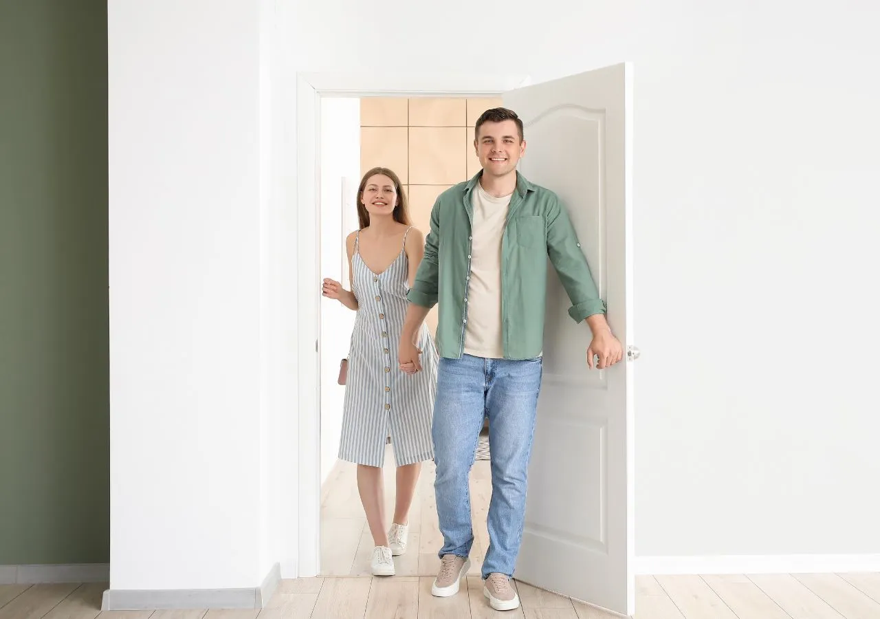 Couple walking into a house