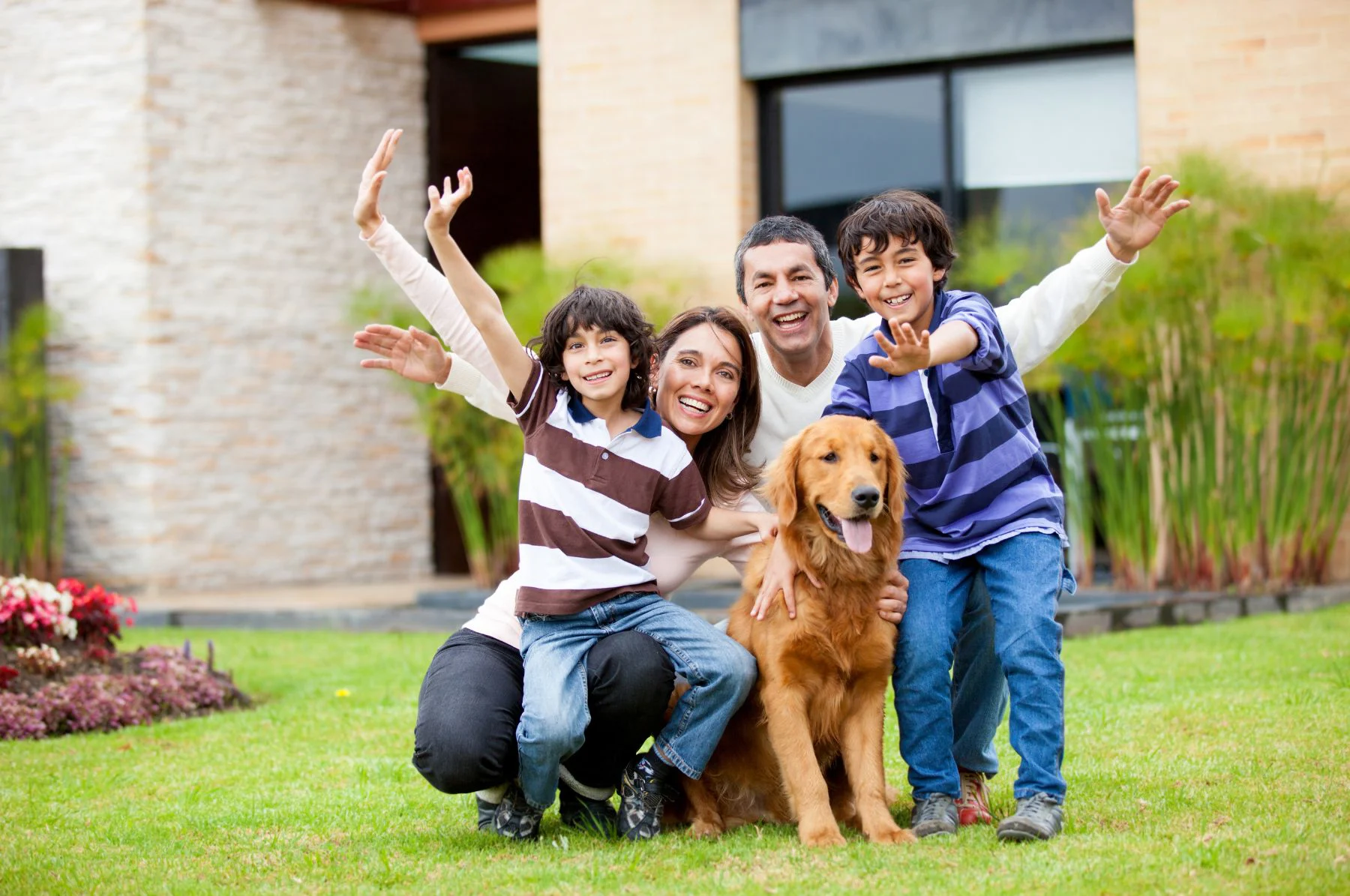 family happy in front garden