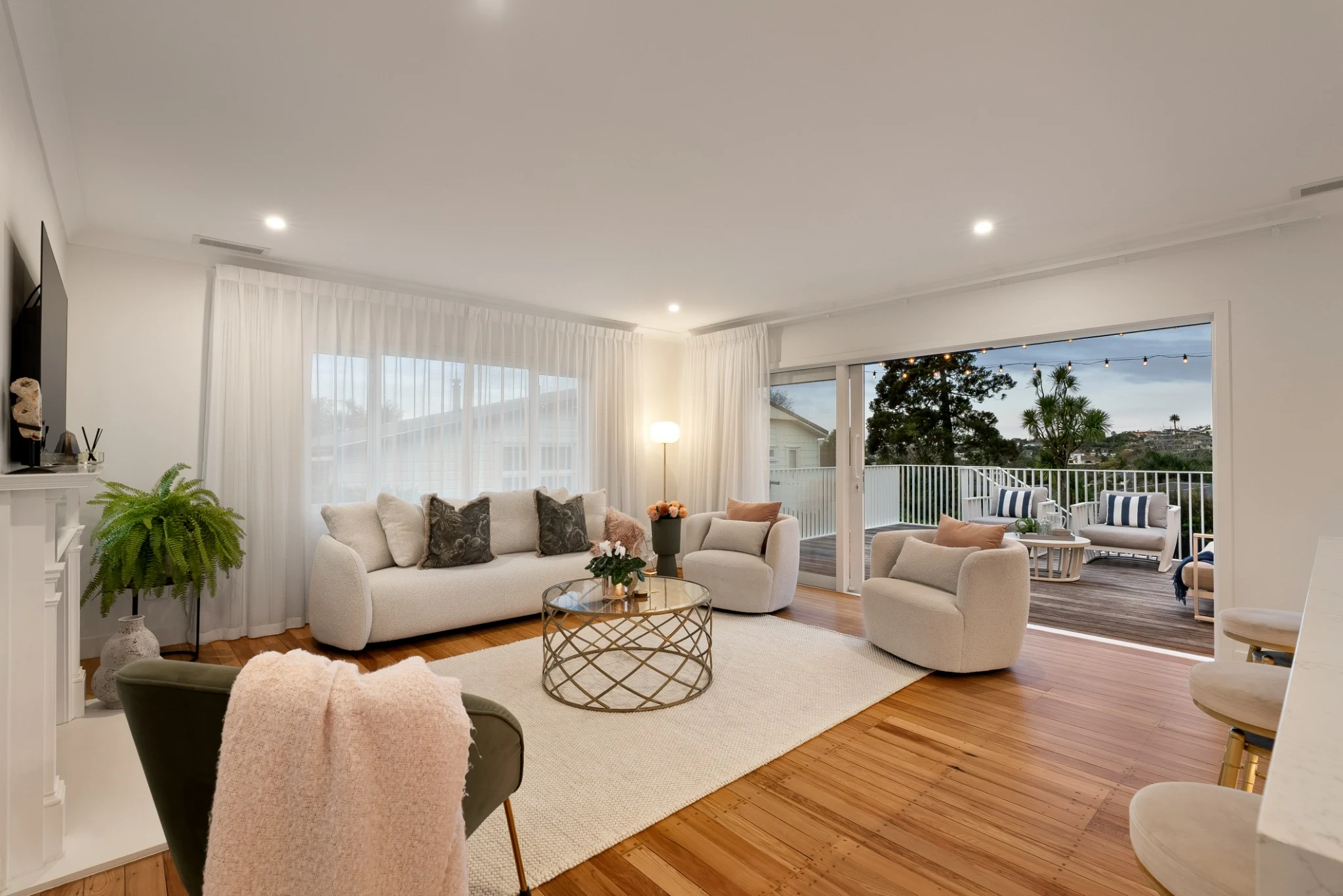 Professionally staged living room at 33 Sale Street opening to the entertaining deck